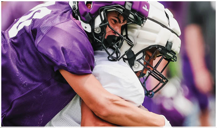A football player is sliding on the ground. Description generated by AI