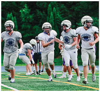 A football player running on the field. Description generated by AI