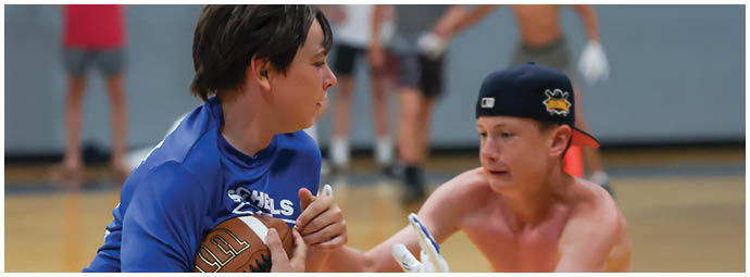 A group of football players wearing black and white uniforms. Description generated by AI