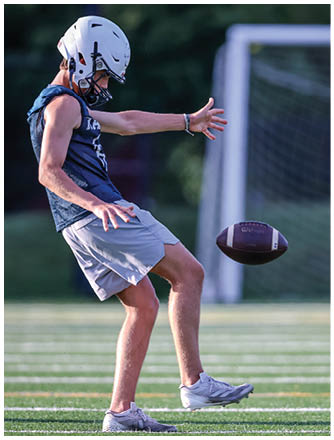 A football player running on the field. Description generated by AI