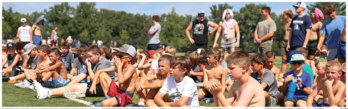 A group of football players on a field. Description generated by AI