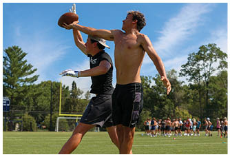 A football player is sliding on the ground. Description generated by AI