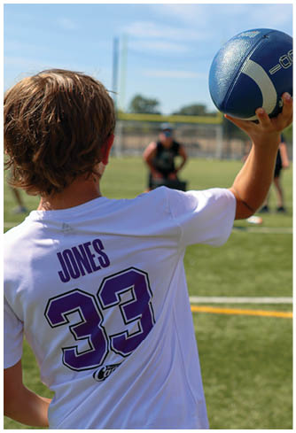 A football player running on the field. Description generated by AI