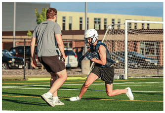 A football player is sliding on the ground. Description generated by AI
