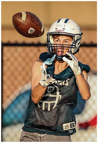 A football player running on the field. Description generated by AI