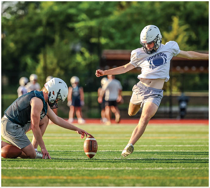 A group of football players wearing black and white uniforms. Description generated by AI