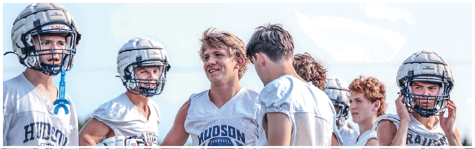 A group of football players on a field. Description generated by AI
