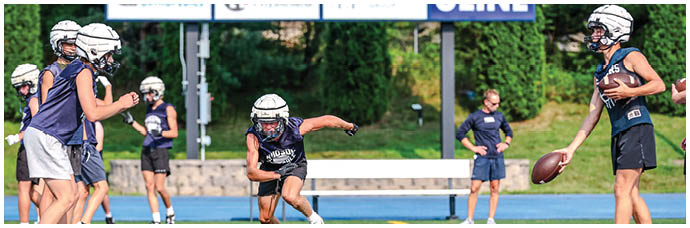 A football player is sliding on the ground. Description generated by AI