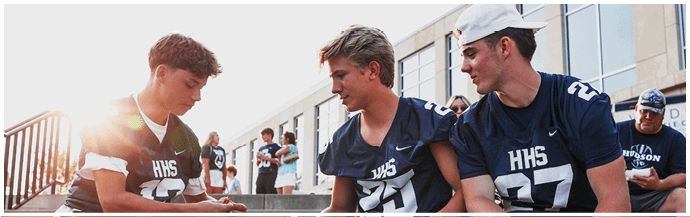 A group of football players on a field. Description generated by AI