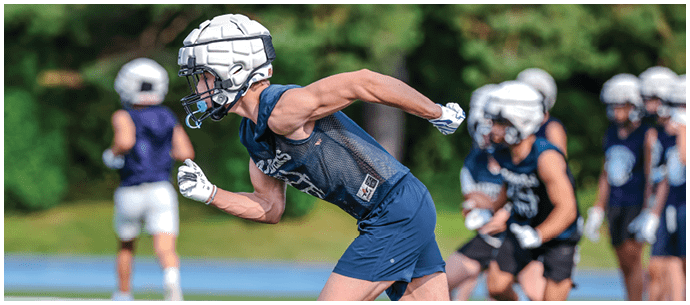 A football player is sliding on the ground. Description generated by AI