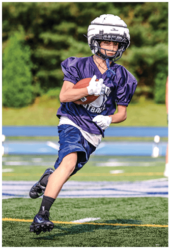 A football player running on the field. Description generated by AI