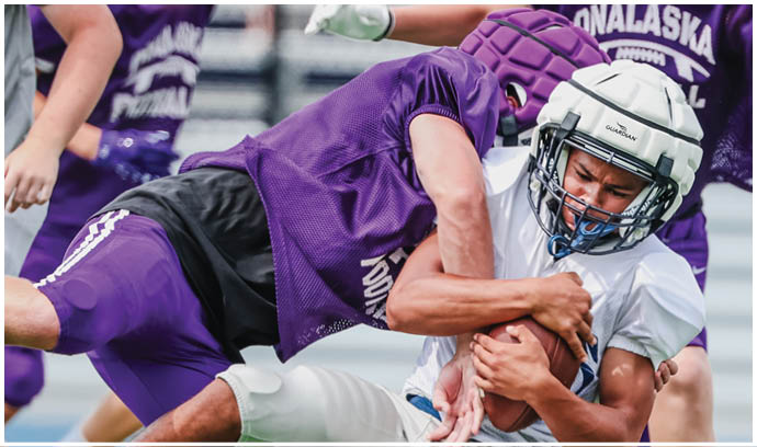 A football player is sliding on the ground. Description generated by AI
