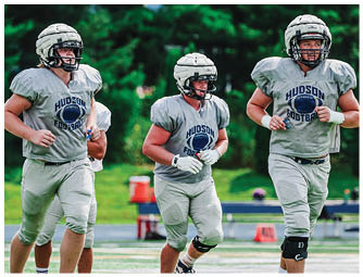 A group of football players on a field. Description generated by AI
