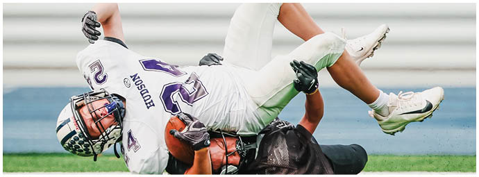 A football player wearing a blue and white uniform. Description generated by AI