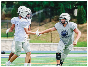 A group of football players on a field. Description generated by AI