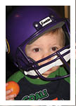 Two football players wearing black jerseys and holding hands. Description generated by AI