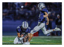 Two football players wearing black jerseys and holding hands. Description generated by AI