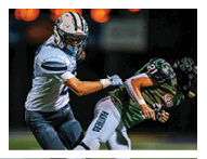 Two football players wearing black jerseys and holding hands. Description generated by AI