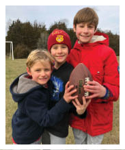 Two football players wearing black jerseys and holding hands. Description generated by AI
