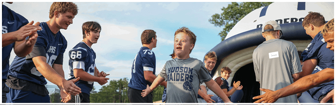 A group of football players on a field. Description generated by AI