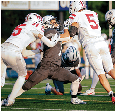 A football game is taking place with a group of men on the field. Description generated by AI