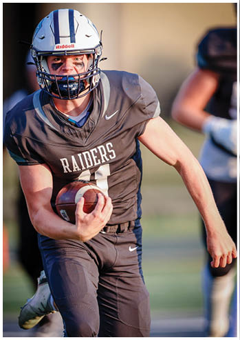 A football player running on the field. Description generated by AI