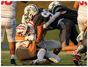 A football player running on the field. Description generated by AI