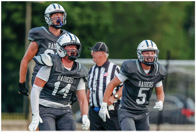 A group of football players wearing black and white uniforms. Description generated by AI