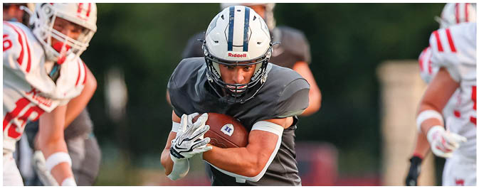 A football player is sliding on the ground. Description generated by AI