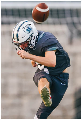 A football player running on the field. Description generated by AI