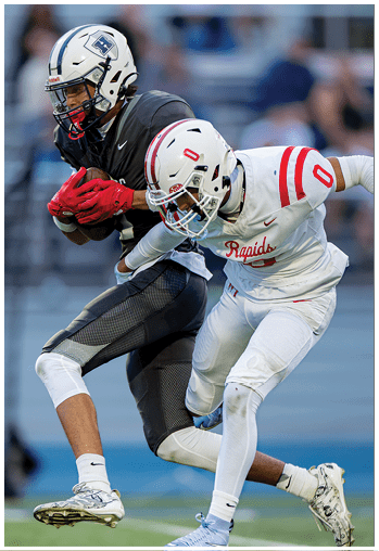 A football player running on the field. Description generated by AI