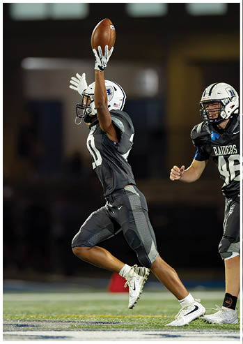 A football player running on the field. Description generated by AI
