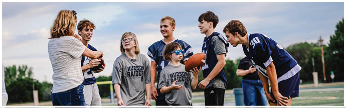 A group of football players on a field. Description generated by AI
