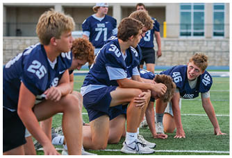A football player is sliding on the ground. Description generated by AI
