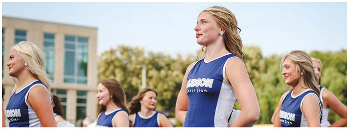 A football player wearing a blue and white uniform. Description generated by AI