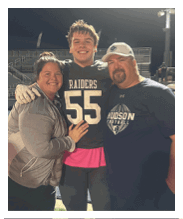 Two football players wearing black jerseys and holding hands. Description generated by AI
