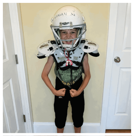Two football players wearing black jerseys and holding hands. Description generated by AI