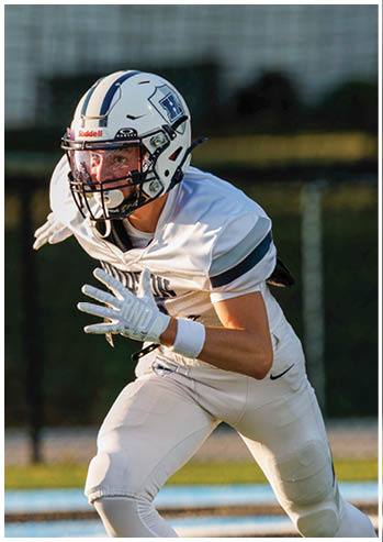 A football player running on the field. Description generated by AI