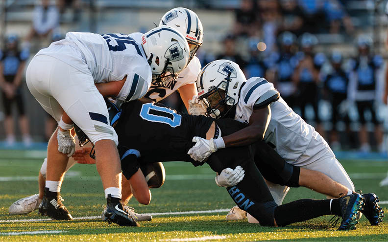 A football player wearing a blue and white jersey with the number 11 on it. Description generated by AI