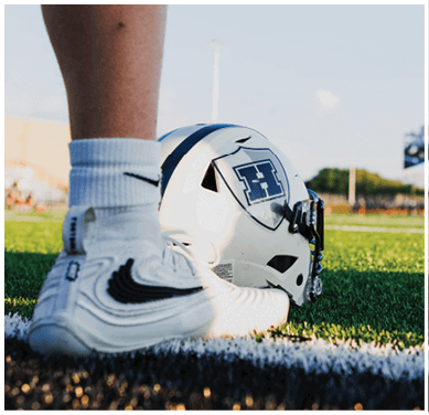 A football game is taking place with a group of men on the field. Description generated by AI