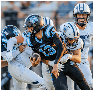 A football game is taking place with a group of men on the field. Description generated by AI