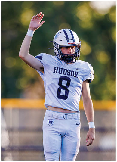 A football player wearing a blue and red jersey. Description generated by AI