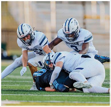 A football game is taking place with a group of men on the field. Description generated by AI