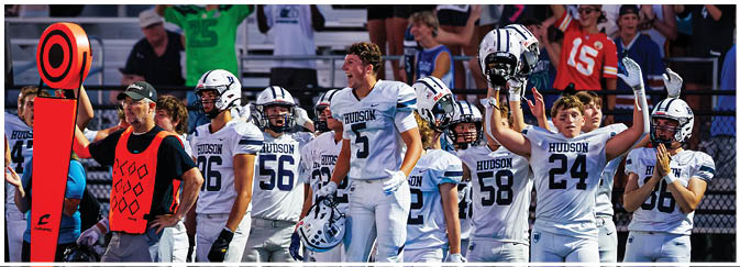 A group of football players on a field. Description generated by AI