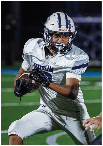 A football player running on the field. Description generated by AI