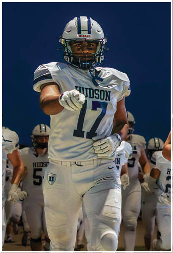 A football player running on the field. Description generated by AI