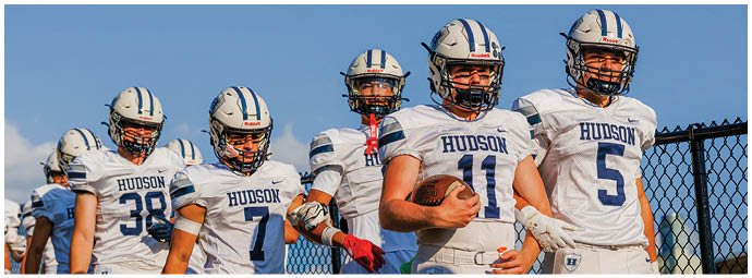 A football player wearing a blue and white uniform. Description generated by AI