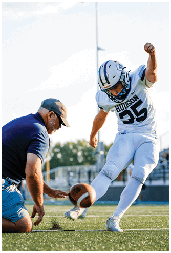 A football game is being played on a field. Description generated by AI