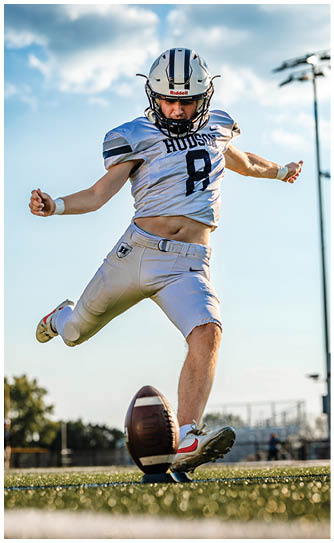 A football player catching a ball. Description generated by AI