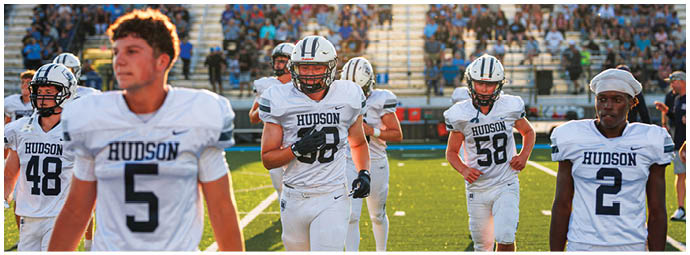 A football player wearing a blue and white uniform. Description generated by AI